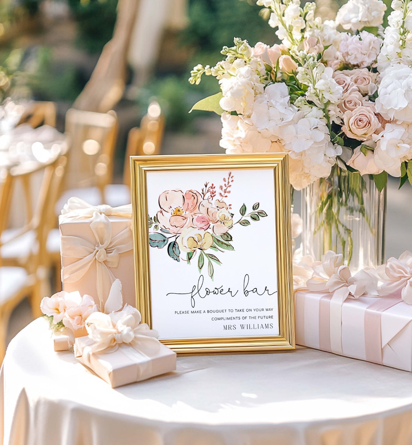 Decorative table setting with a framed sign, flowers, and gift boxes at an event. Vintage Blush Floral Flower Bar Sign, Printable Boho Bridal Shower Flower Station Sign, Bouquet Bar Sign, Flower Station Sign, Cambridge