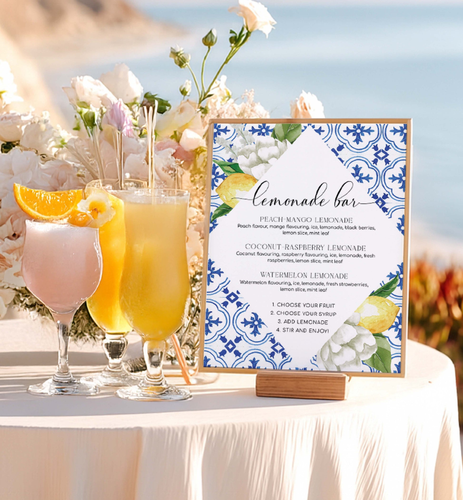 Lemonade bar setup with colorful drinks and a decorative sign on a table outdoors. Lemonade Bar Sign, Mediterranean Blue Tile Lemons, Printable Bridal Shower Bar Sign, Wedding Bar Sign, Italian Theme, Capri, Mocktail Bar Menu, The Med
