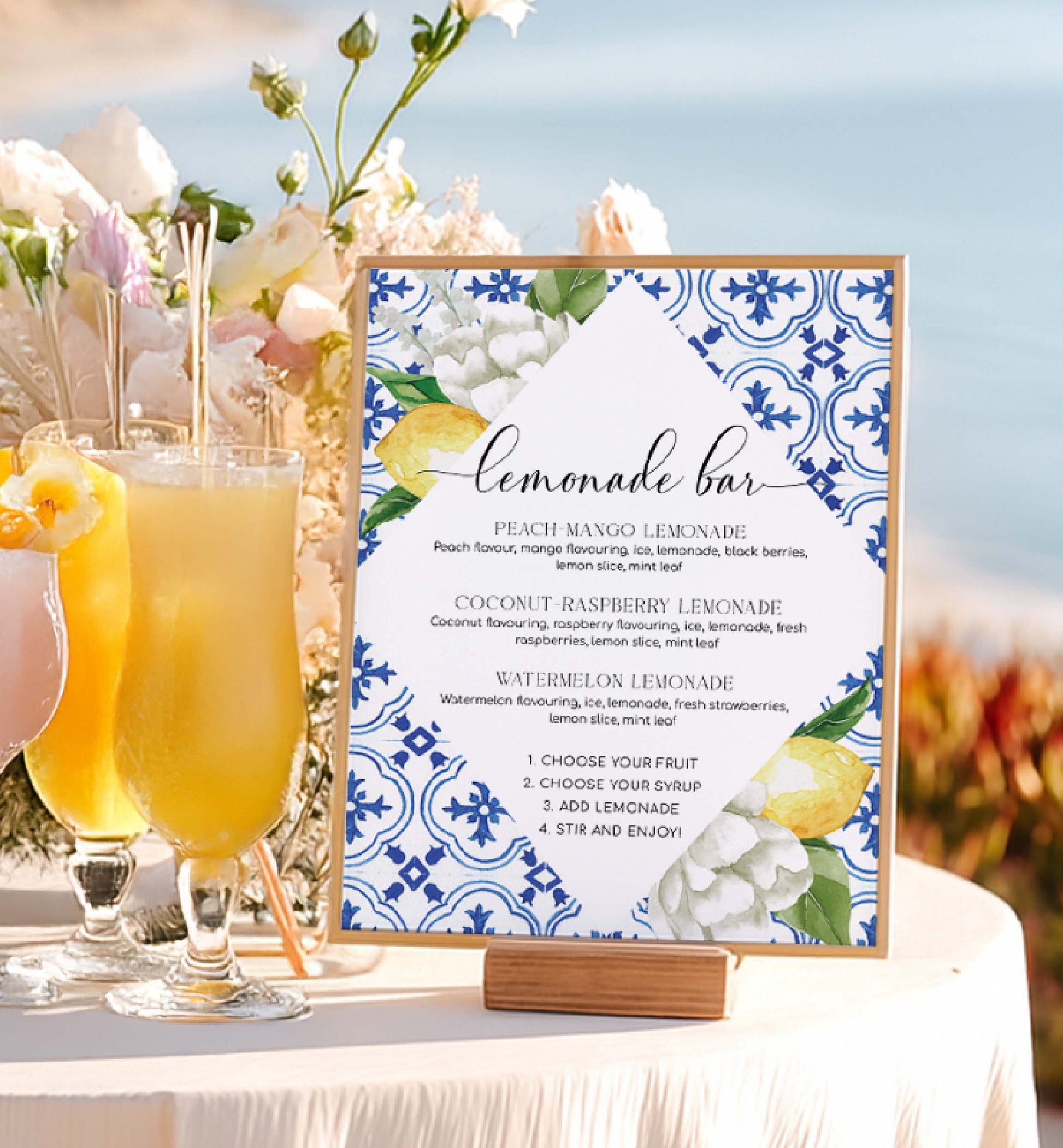 Lemonade bar sign with lemon and floral design next to glasses of lemonade on a table. Lemonade Bar Sign, Mediterranean Blue Tile Lemons, Printable Bridal Shower Bar Sign, Wedding Bar Sign, Italian Theme, Capri, Mocktail Bar Menu, The Med