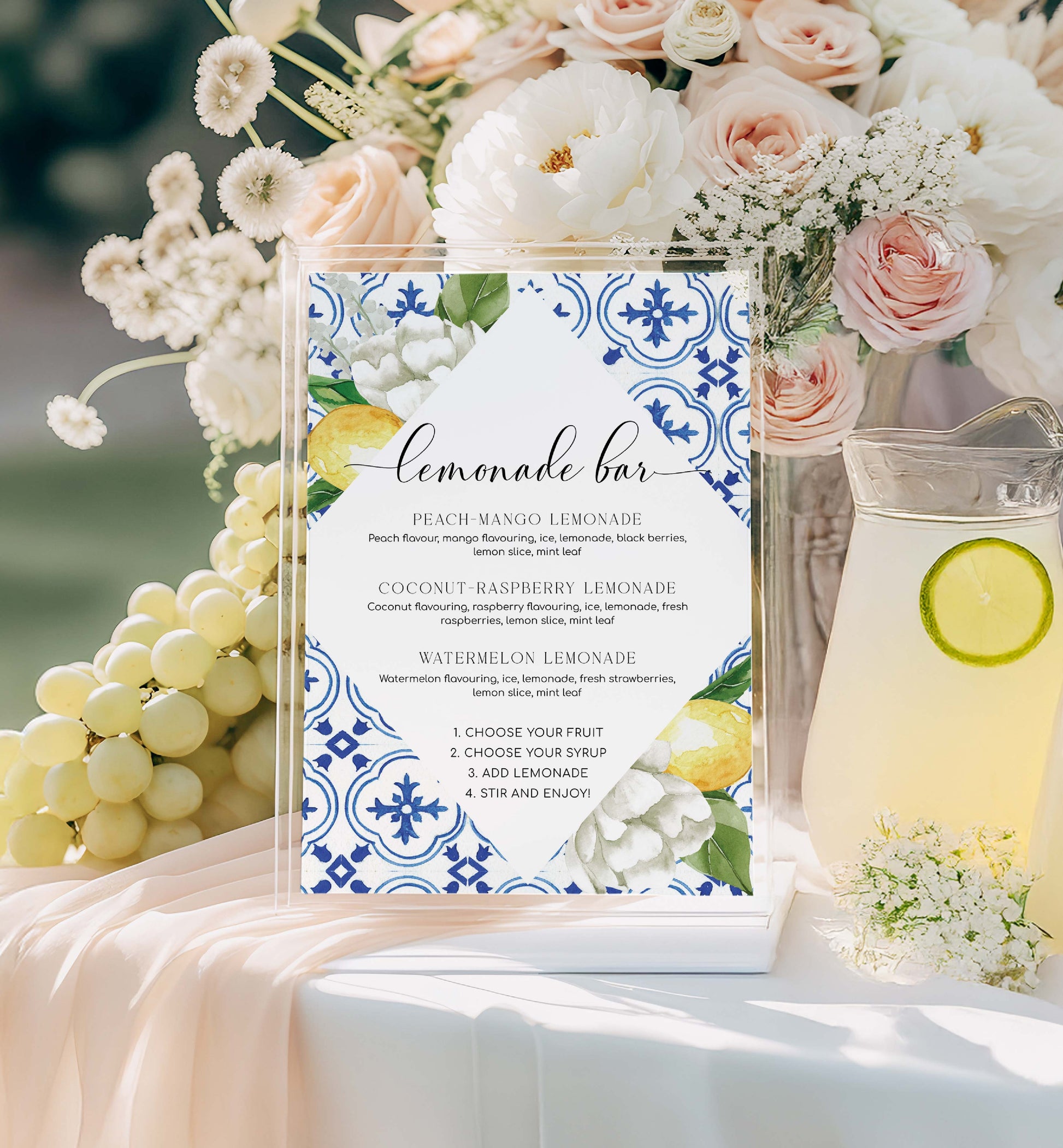 Lemonade bar sign with floral decorations and lemonade pitcher on a table. Lemonade Bar Sign, Mediterranean Blue Tile Lemons, Printable Bridal Shower Bar Sign, Wedding Bar Sign, Italian Theme, Capri, Mocktail Bar Menu, The Med