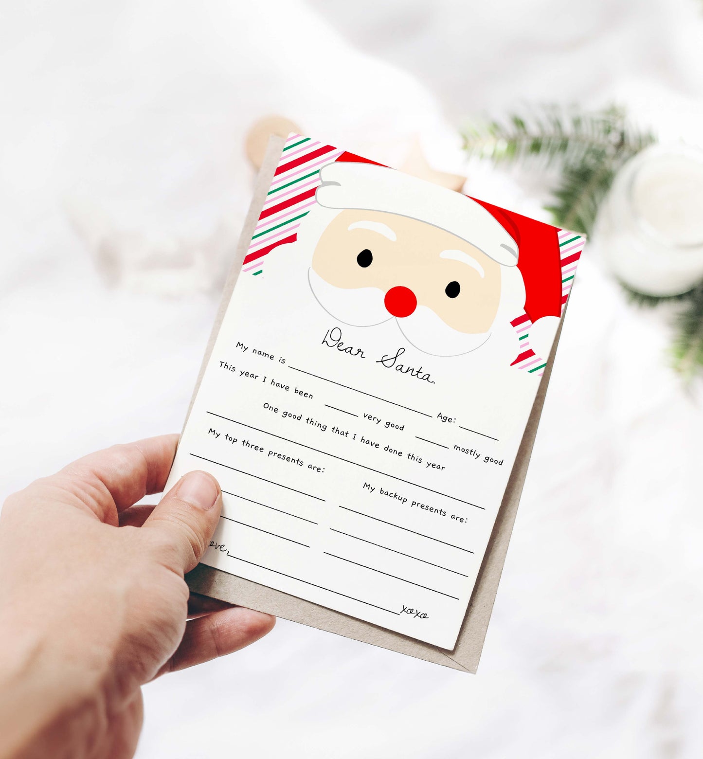 Hand holding a letter to Santa Claus with a festive design on a blurred background. Printable Letter To Santa Template, Christmas Eve Mail for Kids, Children's Christmas Wish List, Dear Santa Christmas Letter, Stripe Pink