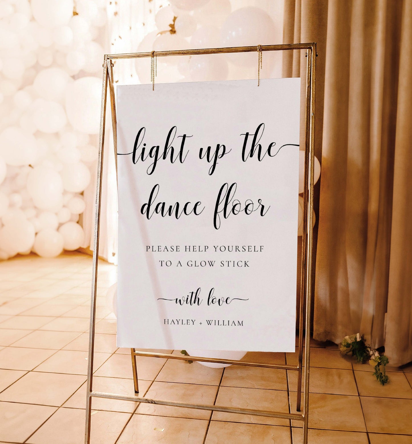 Decorative sign on a stand with text about glow sticks for a dance floor, against a soft background.