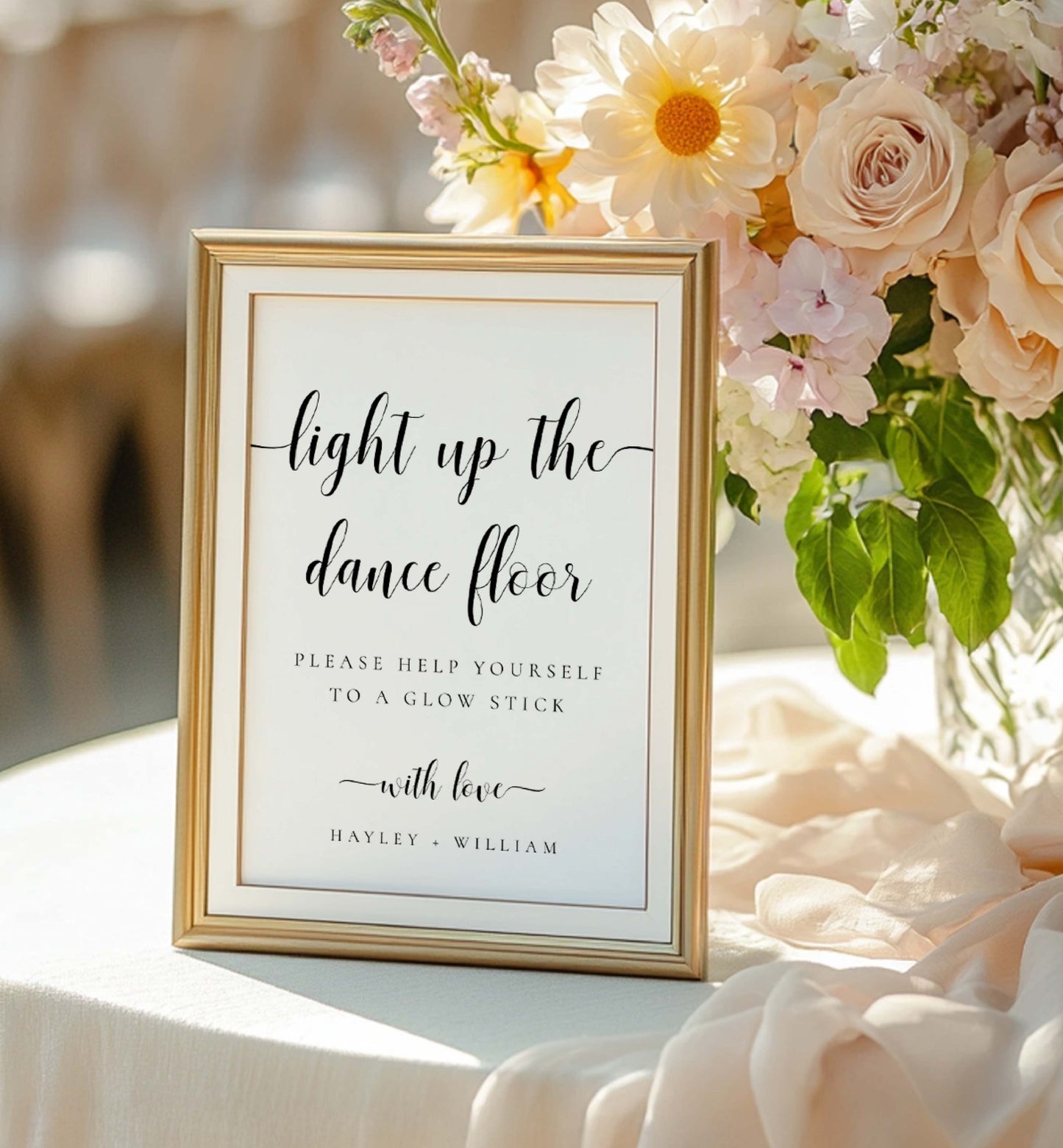 Decorative sign with floral arrangement on a table. Printable Wedding Glow Stick Sign, Minimalist Wedding Light Up The Dance Floor Sign, Editable Let Love Glow Sign Template, Leyton
