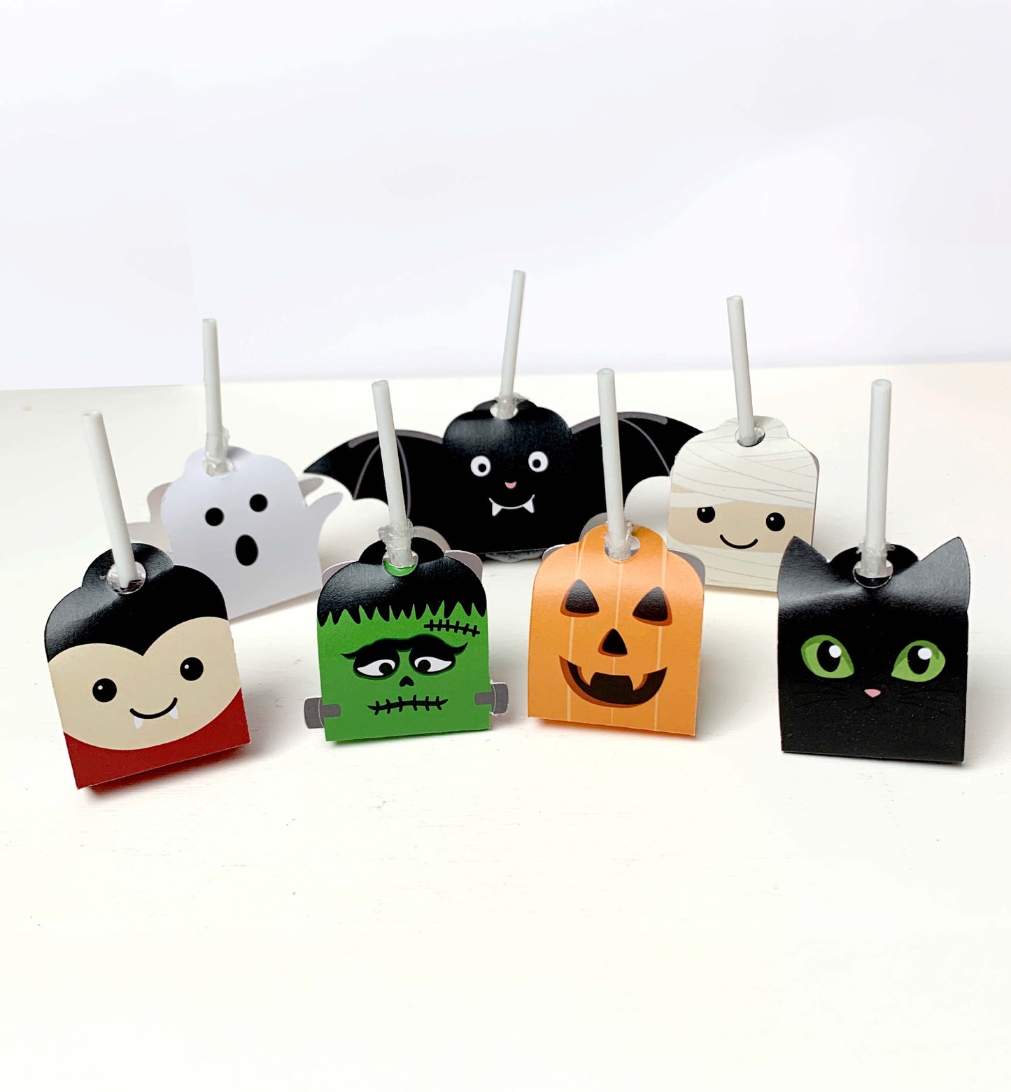 Set of Halloween-themed lollipop holders on a white background. Printable Halloween Lollipop Tags Template, Halloween Trick or Treat Sucker Tag, Kids Classroom Halloween, Friends Halloween Gift
