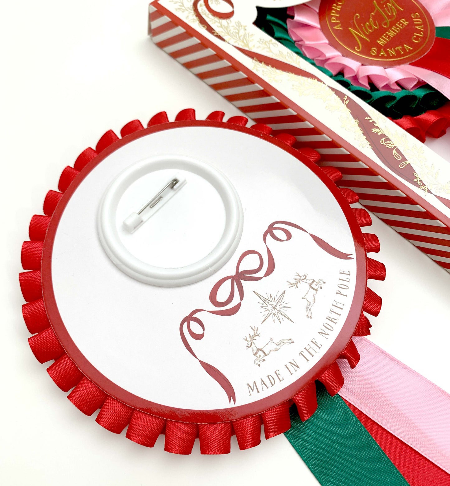 Decorative ribbon with a red border and white center featuring text and graphics on a white background. Nice List Member Rosette Pink Red Green, Christmas Eve Box Gift, Present From Santa Claus, Kids Christmas Gift, Nice List Member Gift