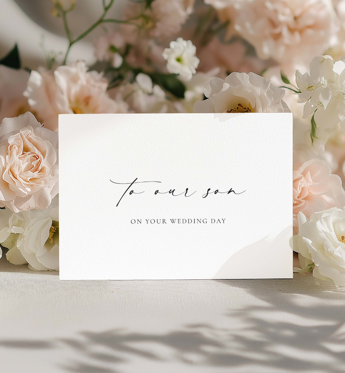 White card with 'To our son on your wedding day' text surrounded by pink and white flowers. To Our Son On Your Wedding Day Card, Modern Minimalist Wedding Day Card, Parents to Groom Wedding Day Card, Ivory, Ellesmere