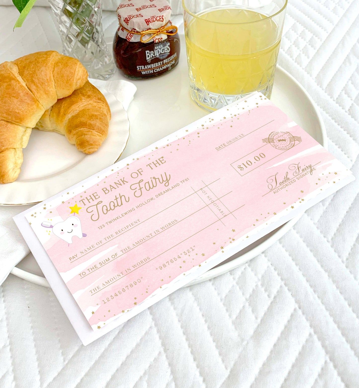 Pink check resembling a bank check with croissants and a glass of juice on a white surface. Printable Tooth Fairy Cheque, Tooth Fairy Money Voucher, Tooth Fairy Payment Certificate, Lost Tooth Gift Voucher, Coupon, Pink Watercolor