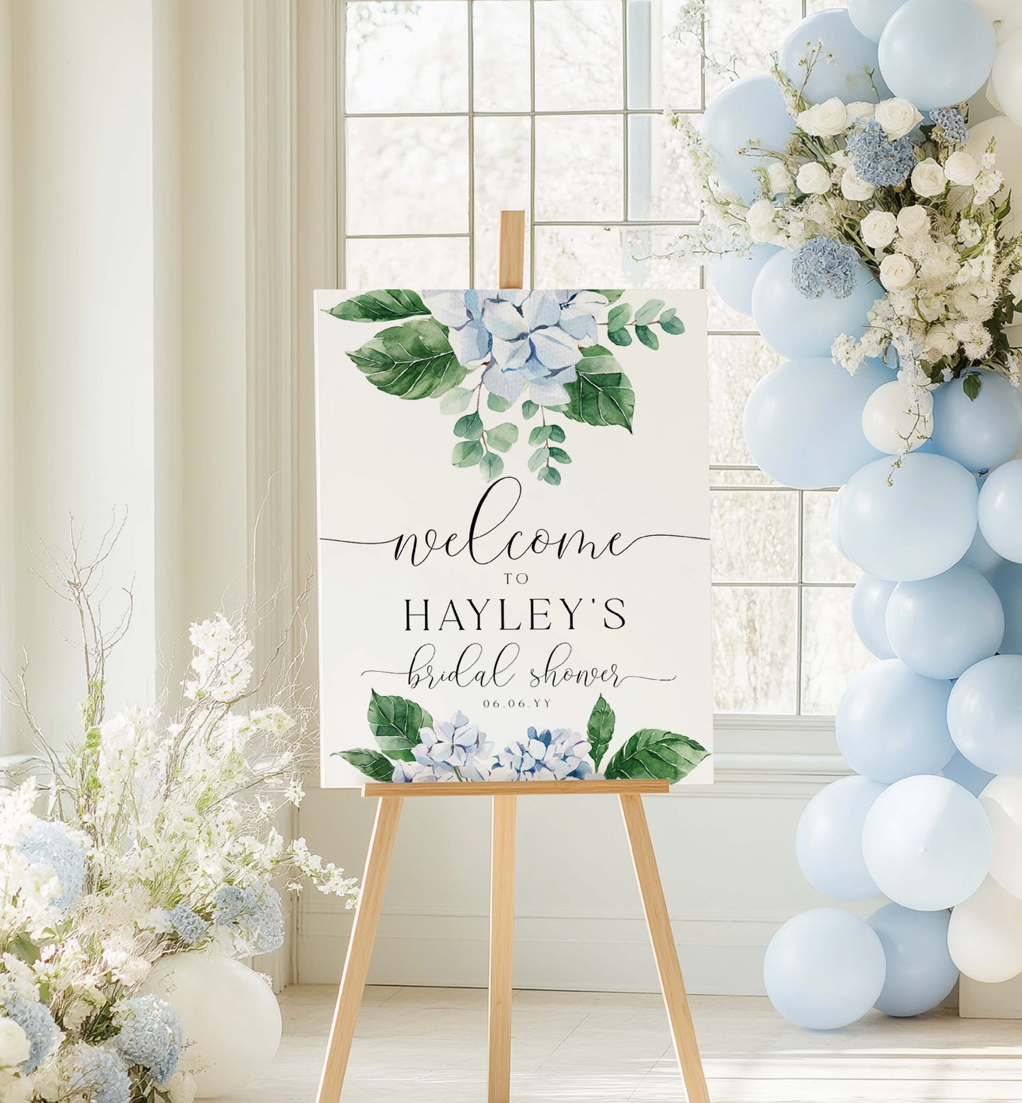 Decorative sign for a bridal shower with floral design and text, placed on an easel against a light interior background. Printable Welcome Sign Template, Blue Hydrangea, Boy Baby Shower Welcome Sign, Bridal Shower Welcome Sign, Wedding Welcome Sign, Ferras