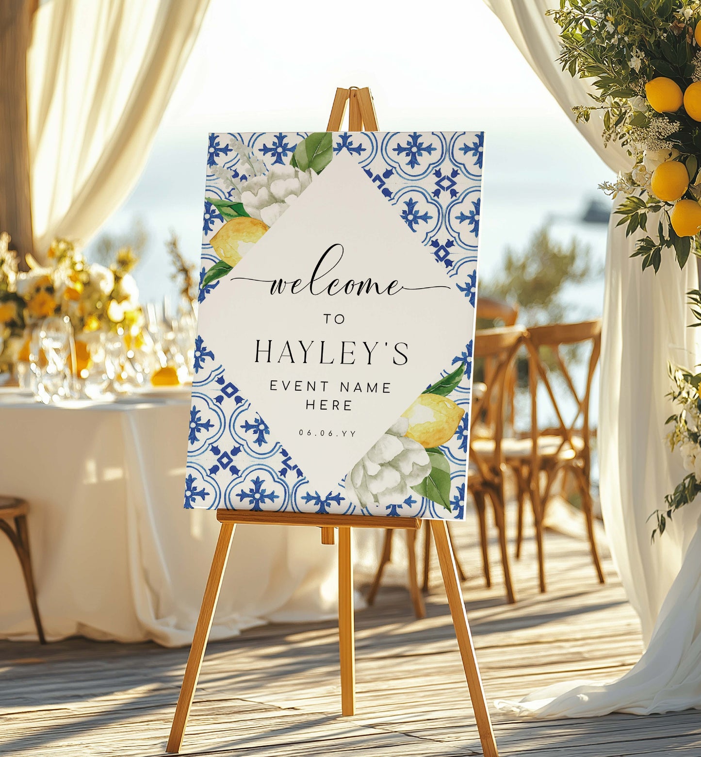 Decorative welcome sign on an easel with floral and lemon design, set outdoors. Mediterranean Blue Tile Lemons Wedding Welcome Sign Template, Printable Capri Lemons Wedding Sign, Bridal Shower Welcome Sign, The Med