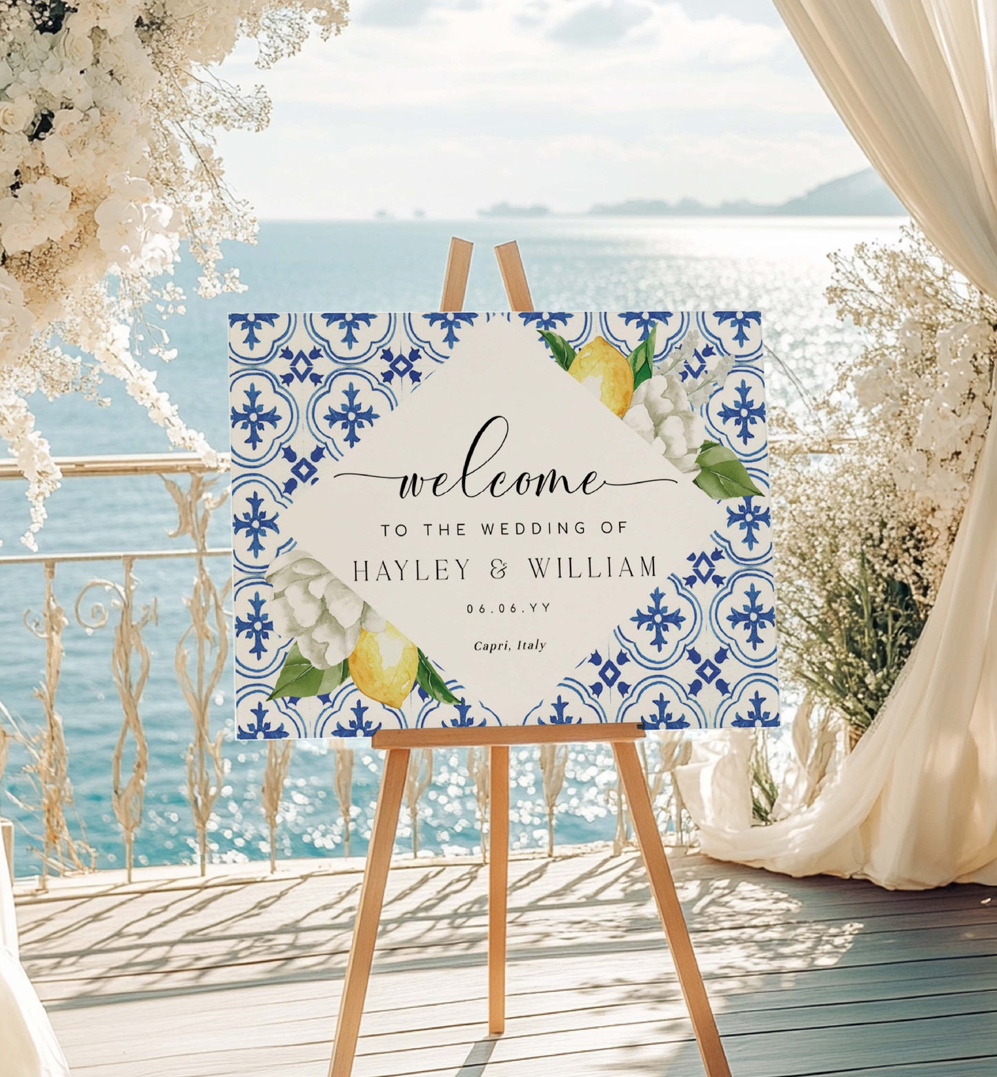 Wedding welcome sign with floral and lemon design on a decorative stand by the sea. Mediterranean Blue Tile Lemons Wedding Welcome Sign Template, Printable Capri Lemons Wedding Sign, Bridal Shower Welcome Sign, The Med