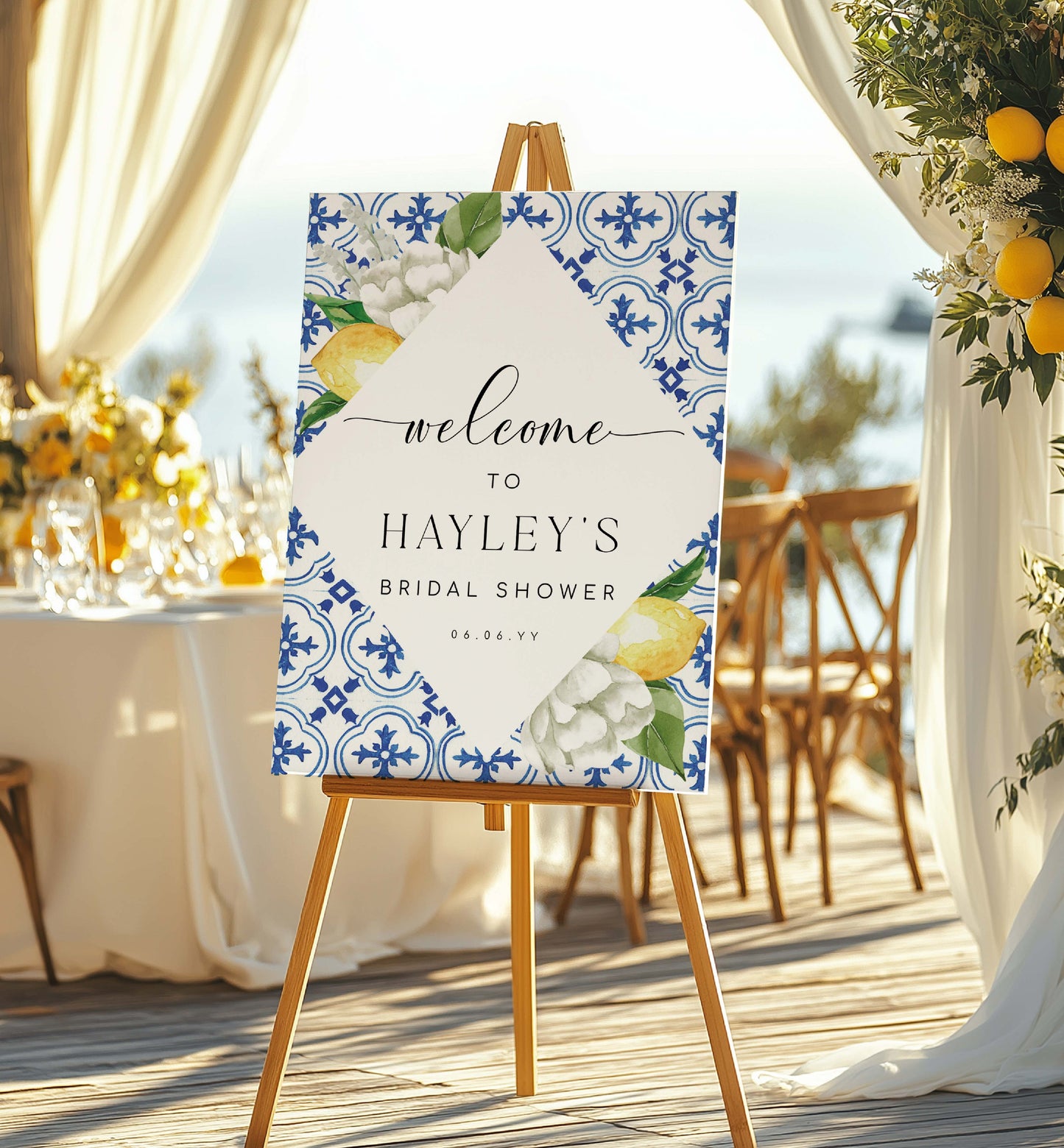 Decorative sign for Hayley's bridal shower with floral and lemon design on an easel outdoors. Mediterranean Blue Tile Lemons Wedding Welcome Sign Template, Printable Capri Lemons Wedding Sign, Bridal Shower Welcome Sign, The Med