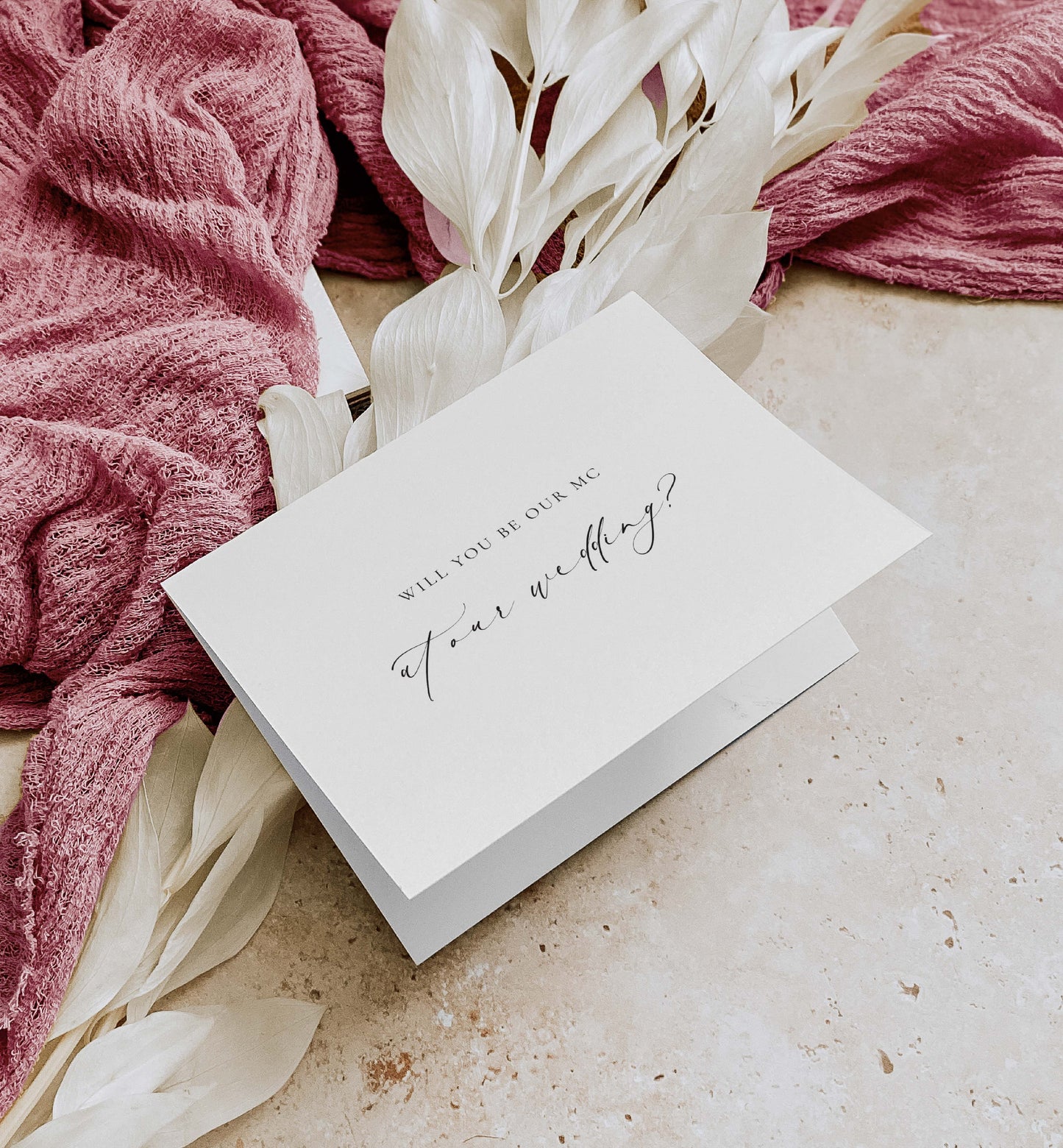 White card with 'Will you be our MC for our wedding?' text on a textured surface with pink fabric and white flowers. Will You Be Our MC Card, Wedding MC Proposal Card, Minimalist Wedding Card, Wedding Proposal Card, Off White Ivory, Ellesmere