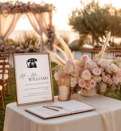 Decorative table setup with floral arrangement, sign, and book at an outdoor event. Printable Voicemail Audio Guestbook Sign, Minimalist Wedding Guestbook Sign, Audio Booth Sign, Phone Message Guest Book Sign, Ellesmere