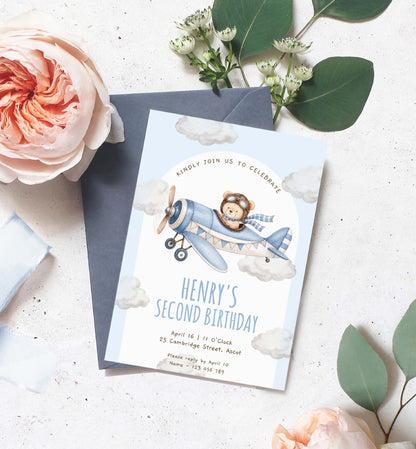 Birthday invitation card with airplane and lion design, surrounded by flowers and leaves on a light surface. Teddy Bear Aeroplane 2nd Birthday Invitation Template (Printable) Plane Blue