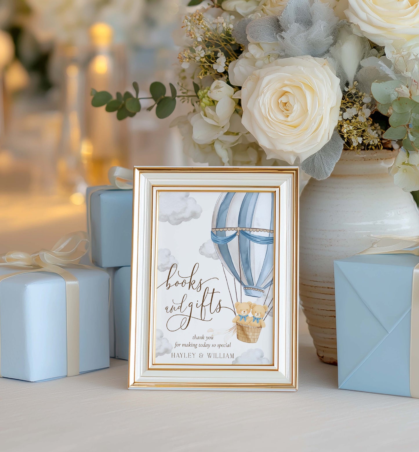 Decorative sign with hot air balloon design in a gold frame, surrounded by flowers and gifts. Printable Books and Gifts Sign Template, Bearly Wait Teddy Bear Hot Air Balloon, Twins Baby Shower Present Table Sign