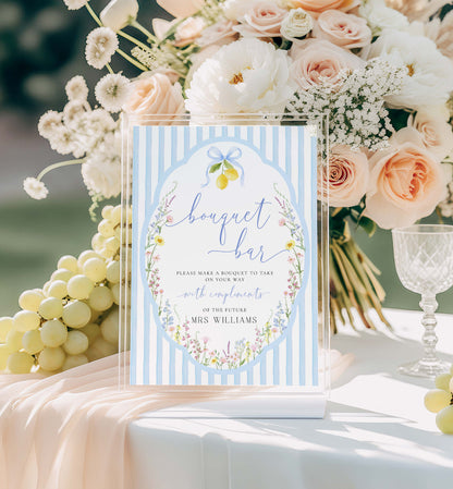 Bouquet bar sign with floral design and text, surrounded by flowers and grapes on a table. Printable Bouquet Bar Sign, Spring Wildflower, Blue Bow Bridal Shower Bouquet Station Favor Sign, Posey