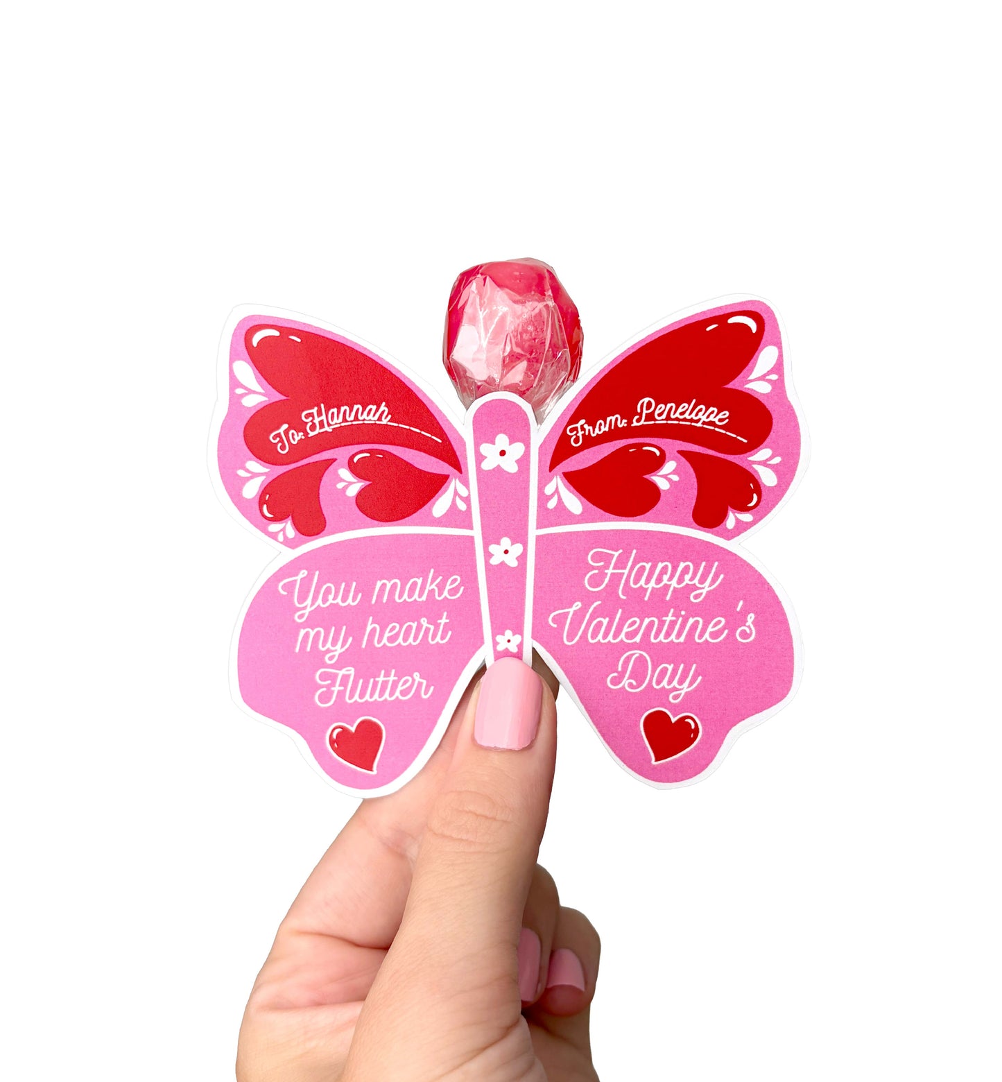 Butterfly-shaped Valentine's Day card with a lollipop, held by a hand. Butterfly Valentine's Day Lollipop Tags Template, Printable You Make My Heart Flutter Lollipop Tag, Pretty Fly Sucker Tag, Kids Valentines