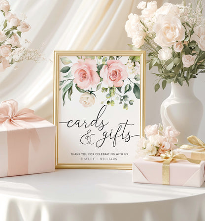 Framed sign with floral design and text, surrounded by flowers and gifts on a table. Printable Cards and Gifts Sign, Blush Floral Wedding Present Table Sign, Printable Baby and Bridal Shower Sign, Darcy Floral Pink