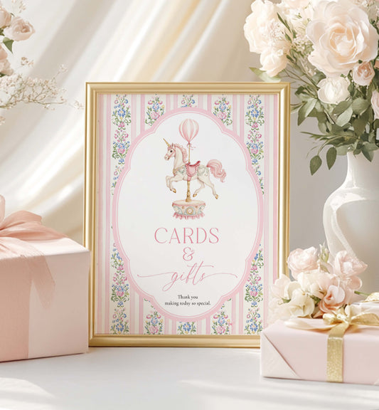 Decorative sign with unicorn design and floral frame, surrounded by flowers and gifts. Printable Cards and Gifts Sign, Vintage Carousel Unicorn Horse, Present Table Sign, Girl Baby Shower Sign, First Birthday Gift Table Sign