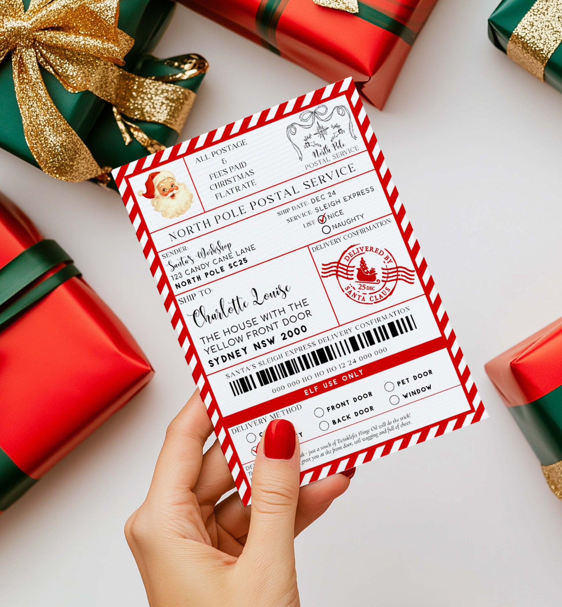 Hand holding a Christmas-themed letter with Santa Claus, surrounded by wrapped presents on a white background. Printable Santa Mail North Pole Shipping Label Sticker, Christmas Special Delivery Shipping Label Template, Christmas Santa Gift Tag