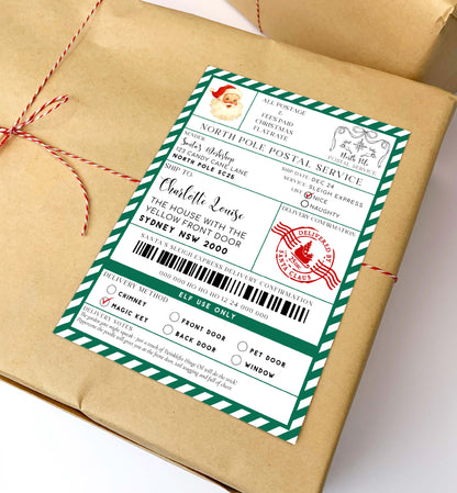 Gift wrapped in brown paper with a festive label on a white background. Printable Santa Mail North Pole Shipping Label Sticker, Christmas Special Delivery Shipping Label Template, Christmas Santa Gift Tag