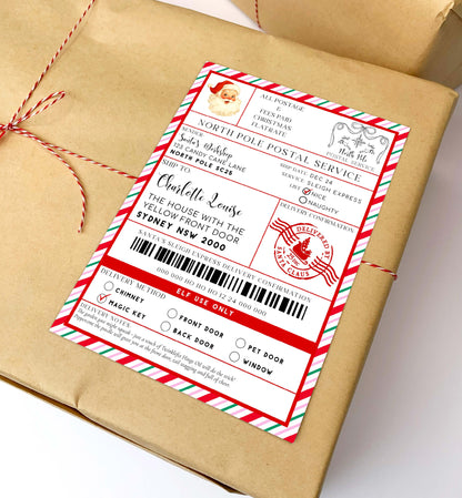 Gift wrapped in brown paper with a festive label on a white background. Printable Santa Mail North Pole Shipping Label Sticker, Christmas Special Delivery Shipping Label Template, Christmas Santa Gift Tag