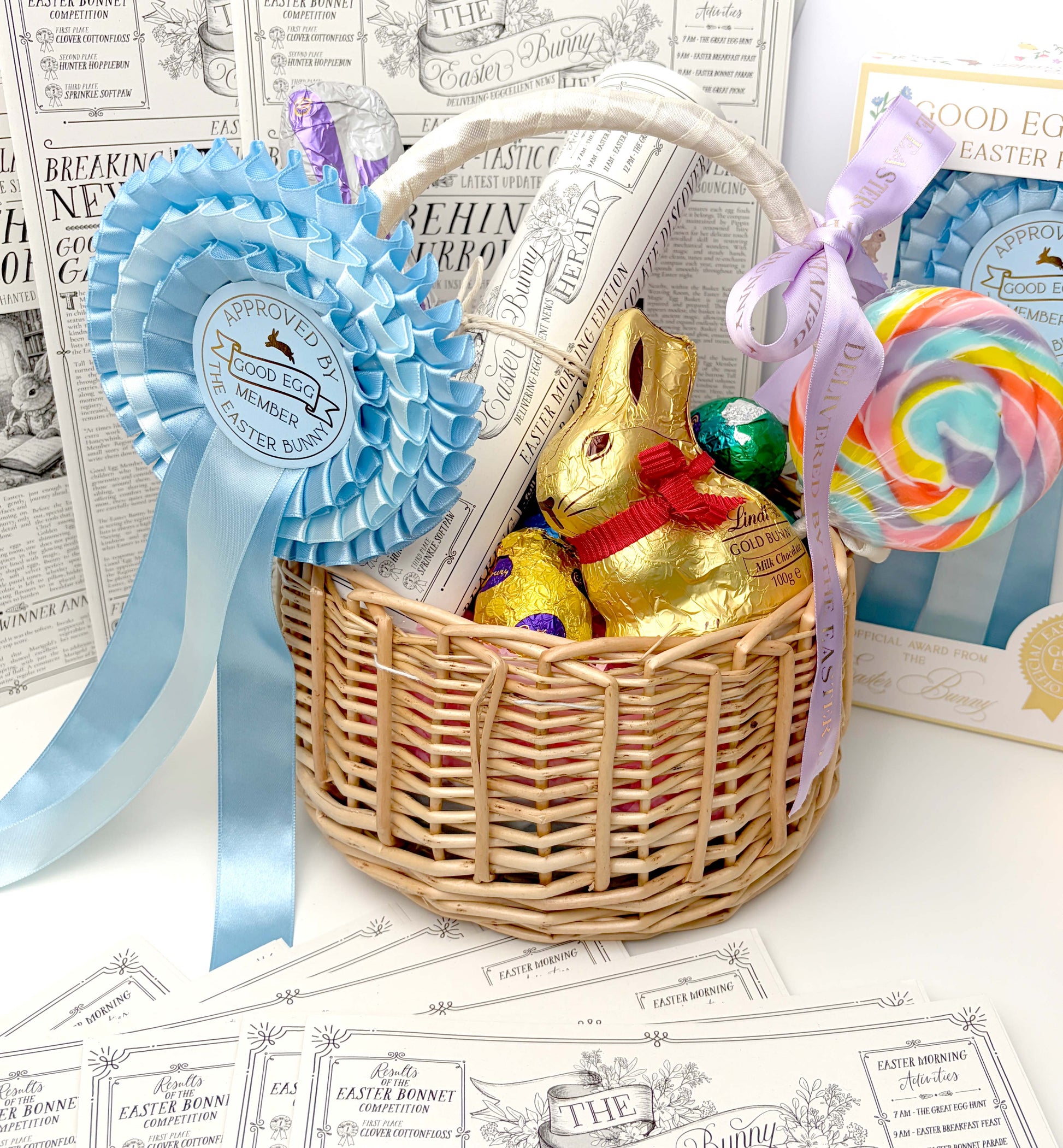 Wicker Easter basket with chocolate bunny, eggs, and candy on a newspaper background. Easter Newspaper Activity Booklet, Basket Basket Gift, Easter Morning Activities, Easter Colouring, Easter Puzzle, Alternative Easter Gift