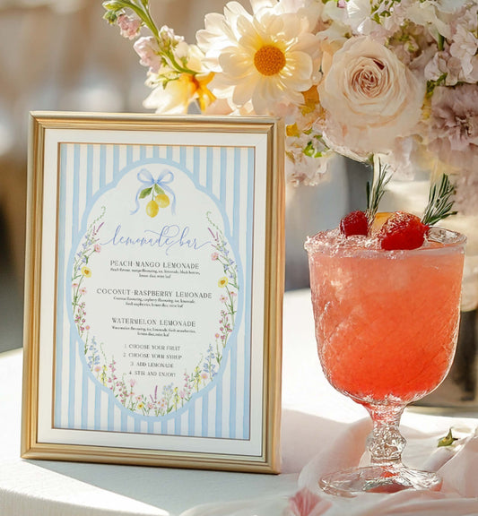 Decorative table setting with floral arrangement, framed card, and cocktails. Printable Lemonade Bar Sign, Blue Bow Ribbon, Bridal Shower Cocktail Menu, Wedding Bar Sign, Italian Lemons, Baby Shower Mocktail, Posey