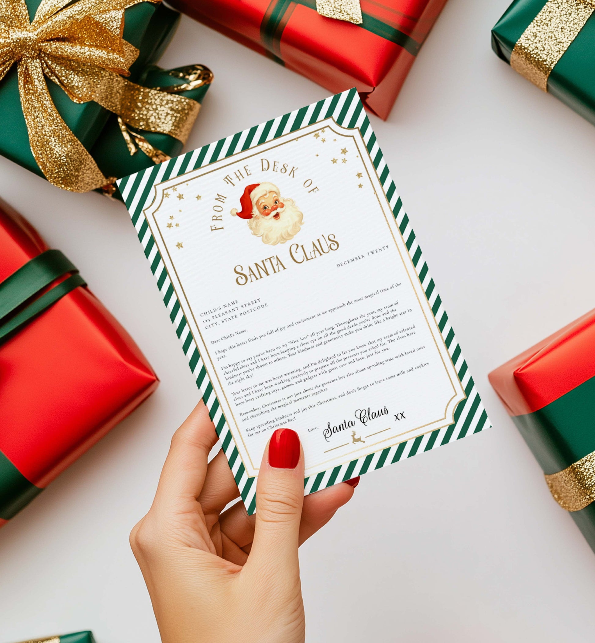 Letter from Santa Claus held by a hand with red nail polish, surrounded by Christmas presents. Printable Letter From Santa Template, Approved Nice List Member Letter From Santa Claus, Christmas Letter From Santa, Stripe Green