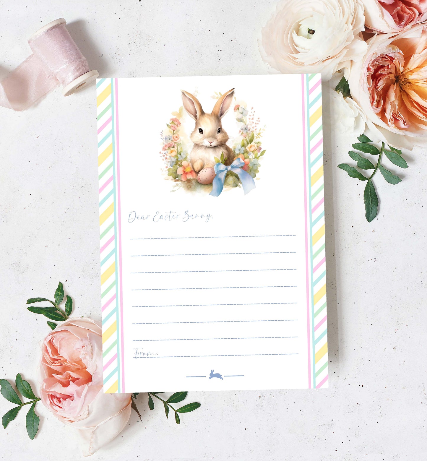 Notepad with Easter design featuring a bunny and flowers on a white surface with flowers and ribbons.