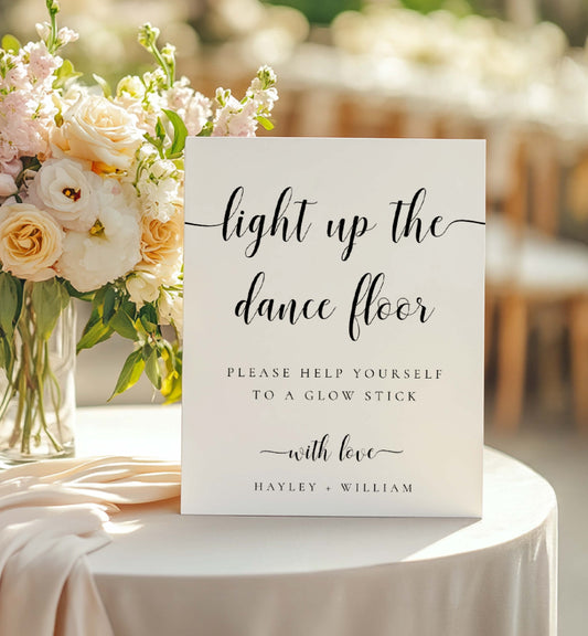 Wedding sign on a table with flowers, inviting guests to use glow sticks. Printable Wedding Glow Stick Sign, Minimalist Wedding Light Up The Dance Floor Sign, Editable Let Love Glow Sign Template, Leyton