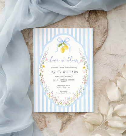 Invitation card with floral design and lemon illustrations on a marble surface with fabric. Printable Love In Bloom Shower Invitation Template, Something Blue Bridal Shower Invite, Spring Wildflower Bridal Brunch Evite, Posey
