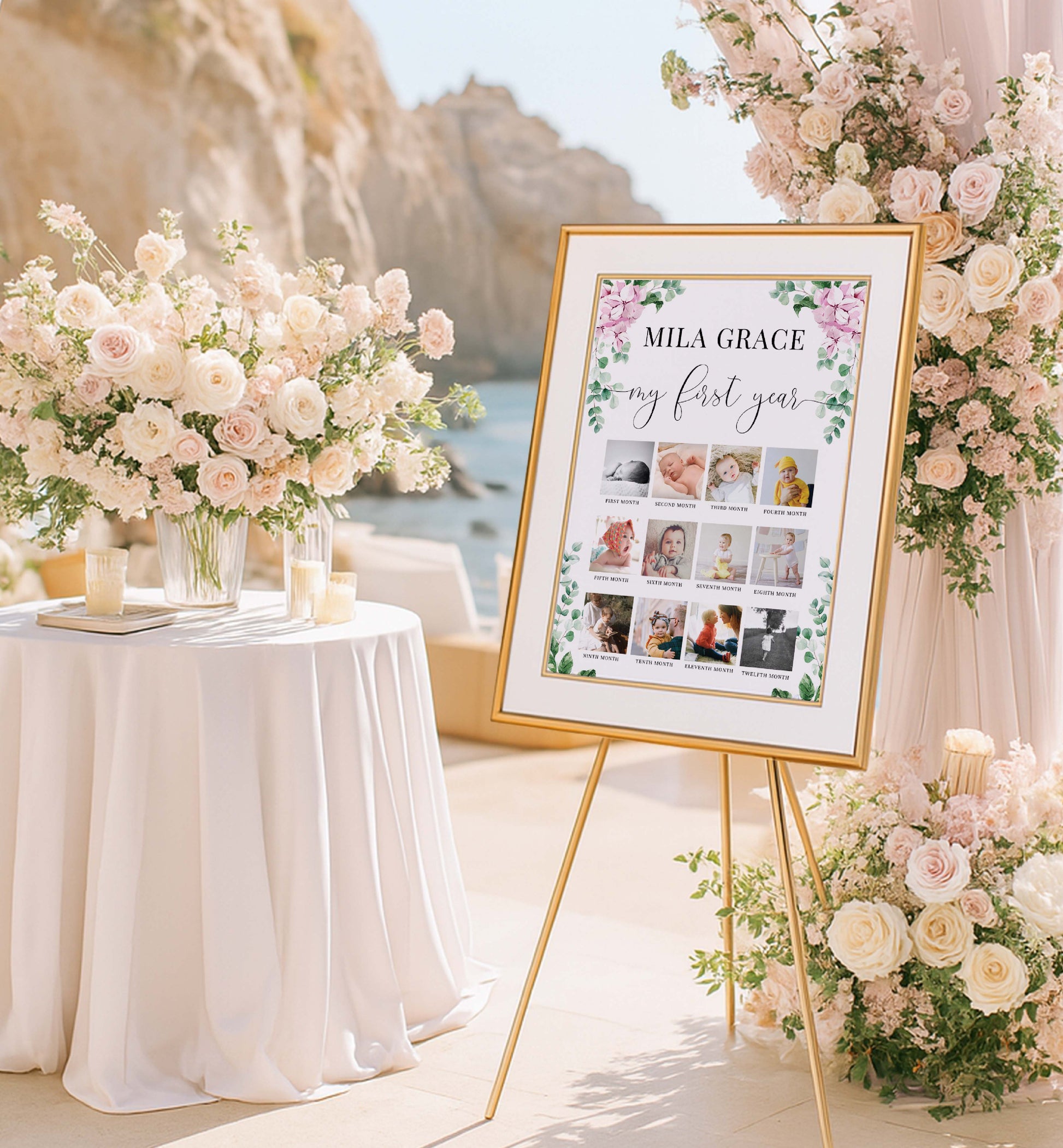 Decorative setup with a framed photo display and floral arrangements by a scenic location.