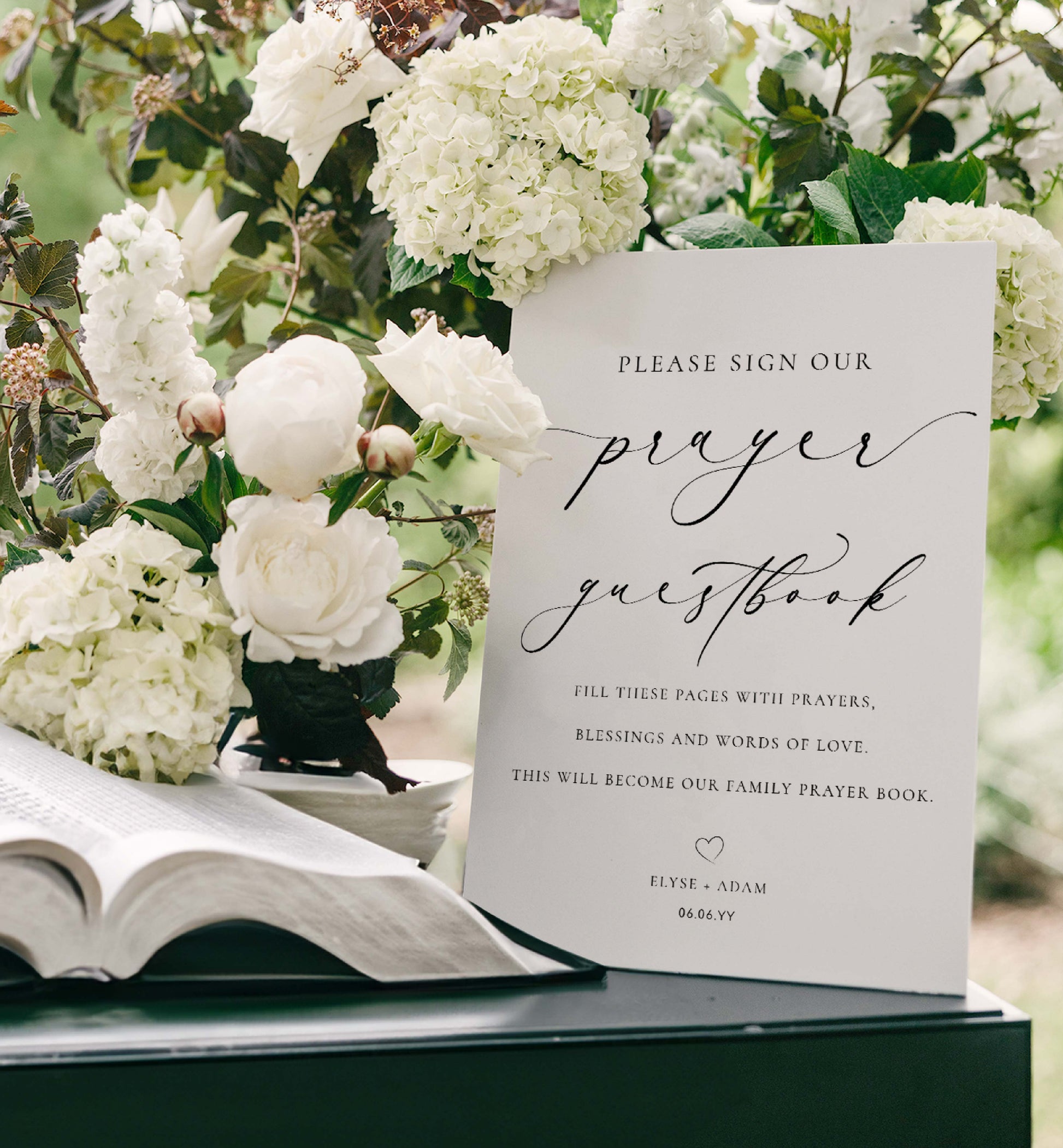 Open book with a 'please sign our prayer guestbook' card surrounded by white flowers. Minimalist Wedding Prayer Guestbook Sign (Printable), Bible Guestbook