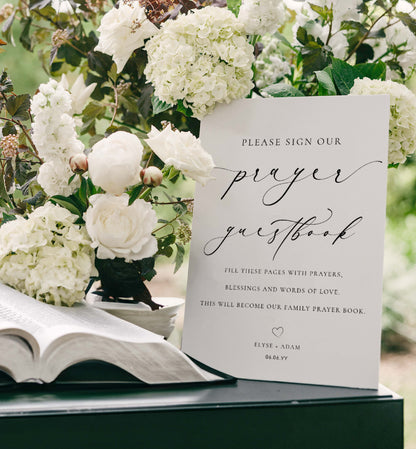 Open book with a 'please sign our prayer guestbook' card surrounded by white flowers. Minimalist Wedding Prayer Guestbook Sign (Printable), Bible Guestbook
