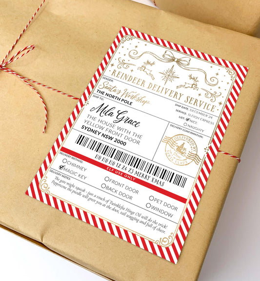 A brown kraft paper gift box wrapped with red-and-white string and a decorative holiday shipping label, photographed on a clean white background.