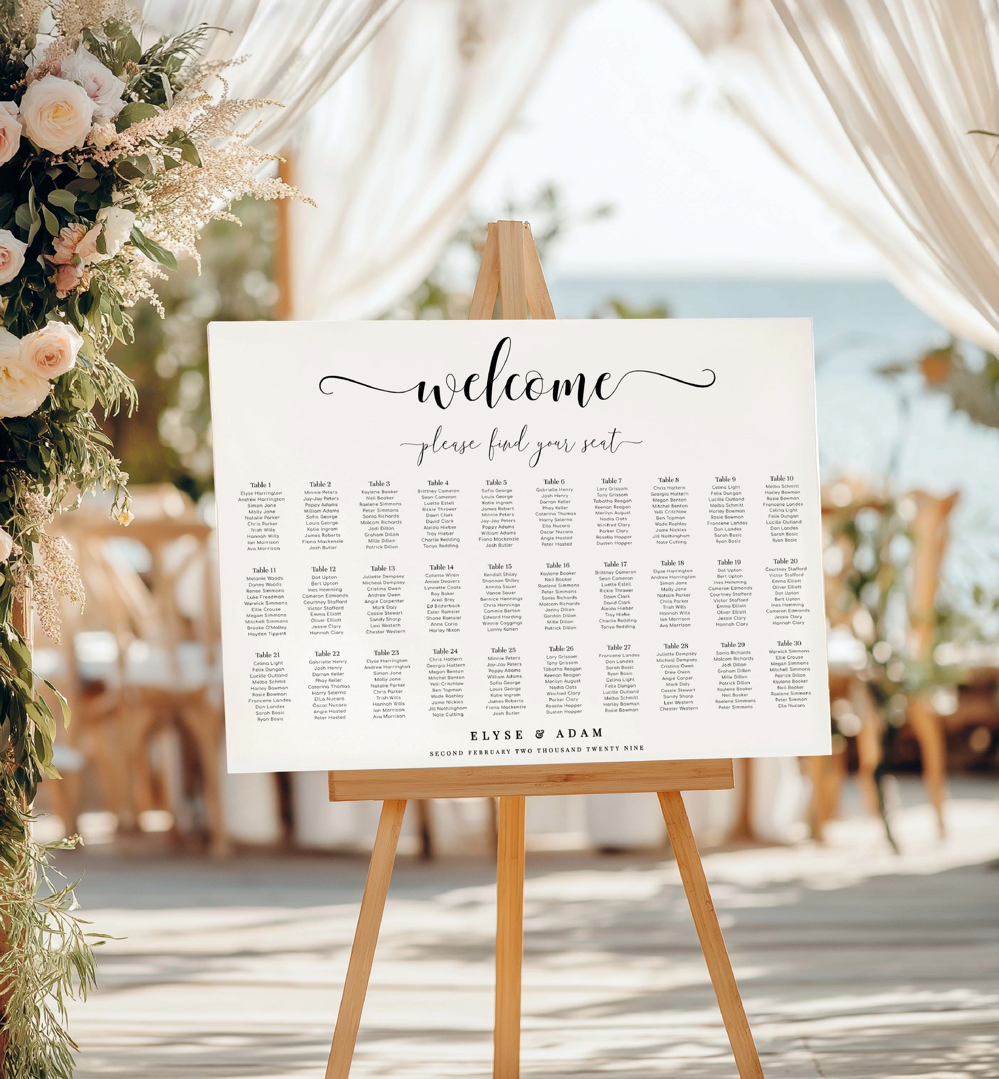 Seating chart sign on an easel with floral decorations and chairs in the background. Minimalist Wedding Seating Chart, Printable Modern Seating Chart Board, Simple Clean Wedding Seating Sign, Wedding Poster, 20 table seating chart, 30 table seating chart