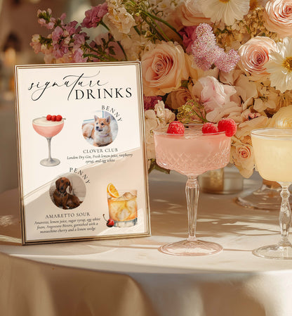 Signature drinks sign with cocktail illustrations and a floral arrangement on a table.