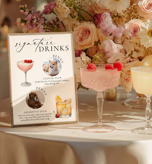 Signature drinks sign with cocktail illustrations and a floral arrangement on a table.