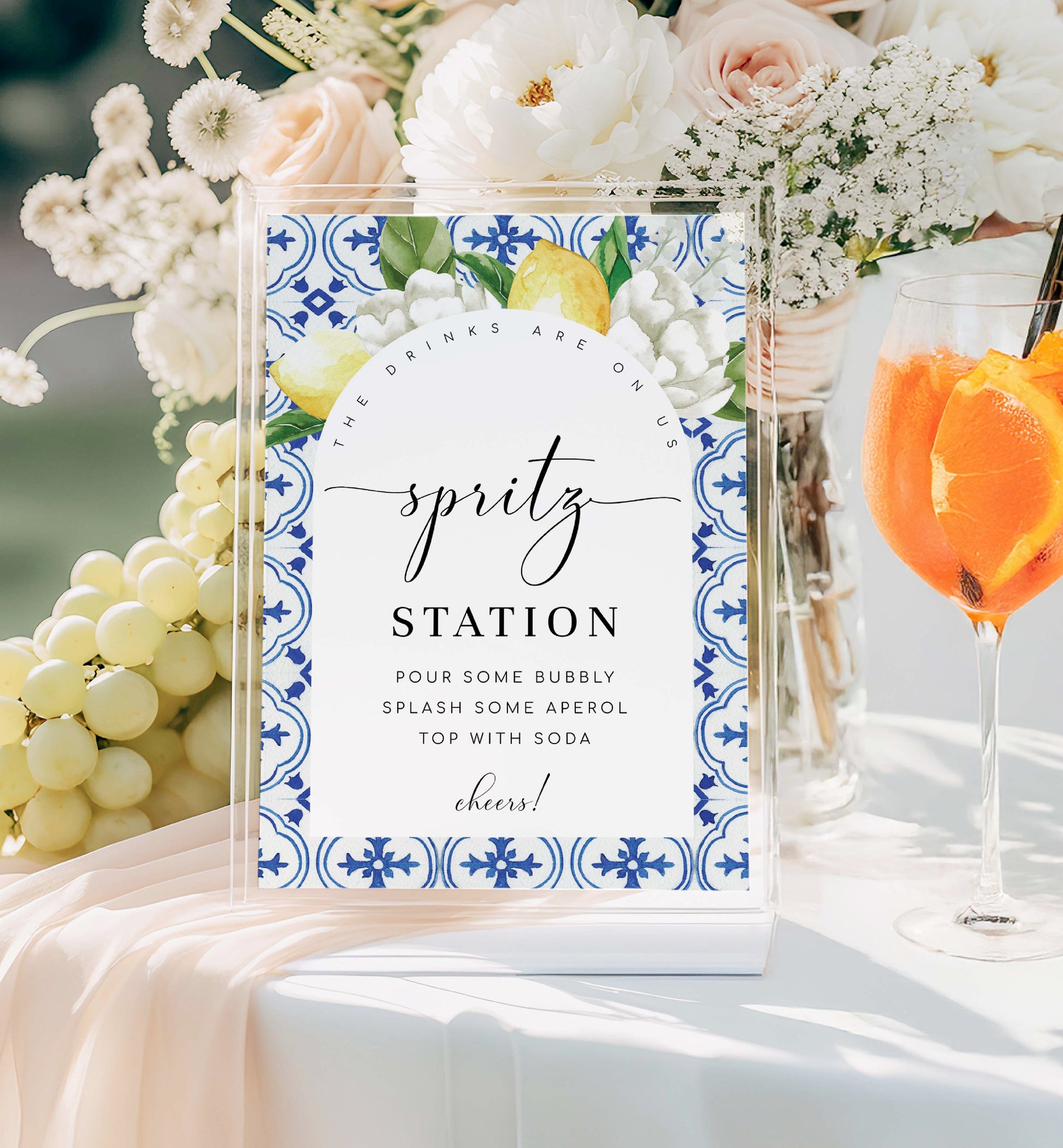 Spritz station sign with floral design and text, surrounded by flowers and drinks. Printable Spritz Station Sign, Orange Spritz Cocktail Sign, Mediterranean Blue Tile, Lemons Wedding Cocktail Bar Sign, Signature Drinks Sign