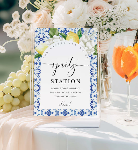 Spritz station sign with floral design and text, surrounded by flowers and drinks. Printable Spritz Station Sign, Orange Spritz Cocktail Sign, Mediterranean Blue Tile, Lemons Wedding Cocktail Bar Sign, Signature Drinks Sign