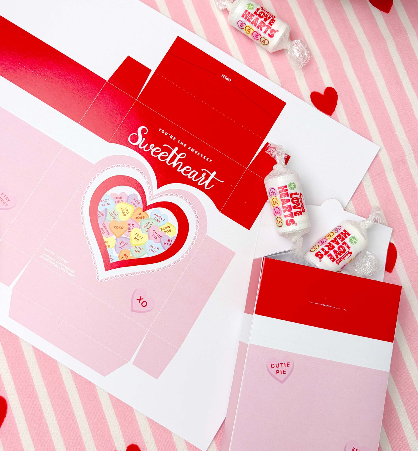 Valentine's Day-themed packaging with heart designs and candy on a pink background. Sweetheart Candy Valentine's Day Favor Box (DIY Printable Download)