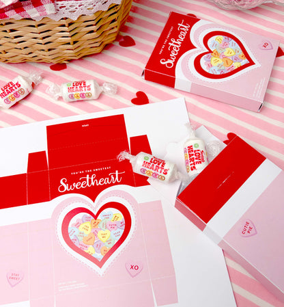 Valentine's Day-themed candy and packaging on a pink and white striped background. Sweetheart Candy Valentine's Day Favor Box (DIY Printable Download)