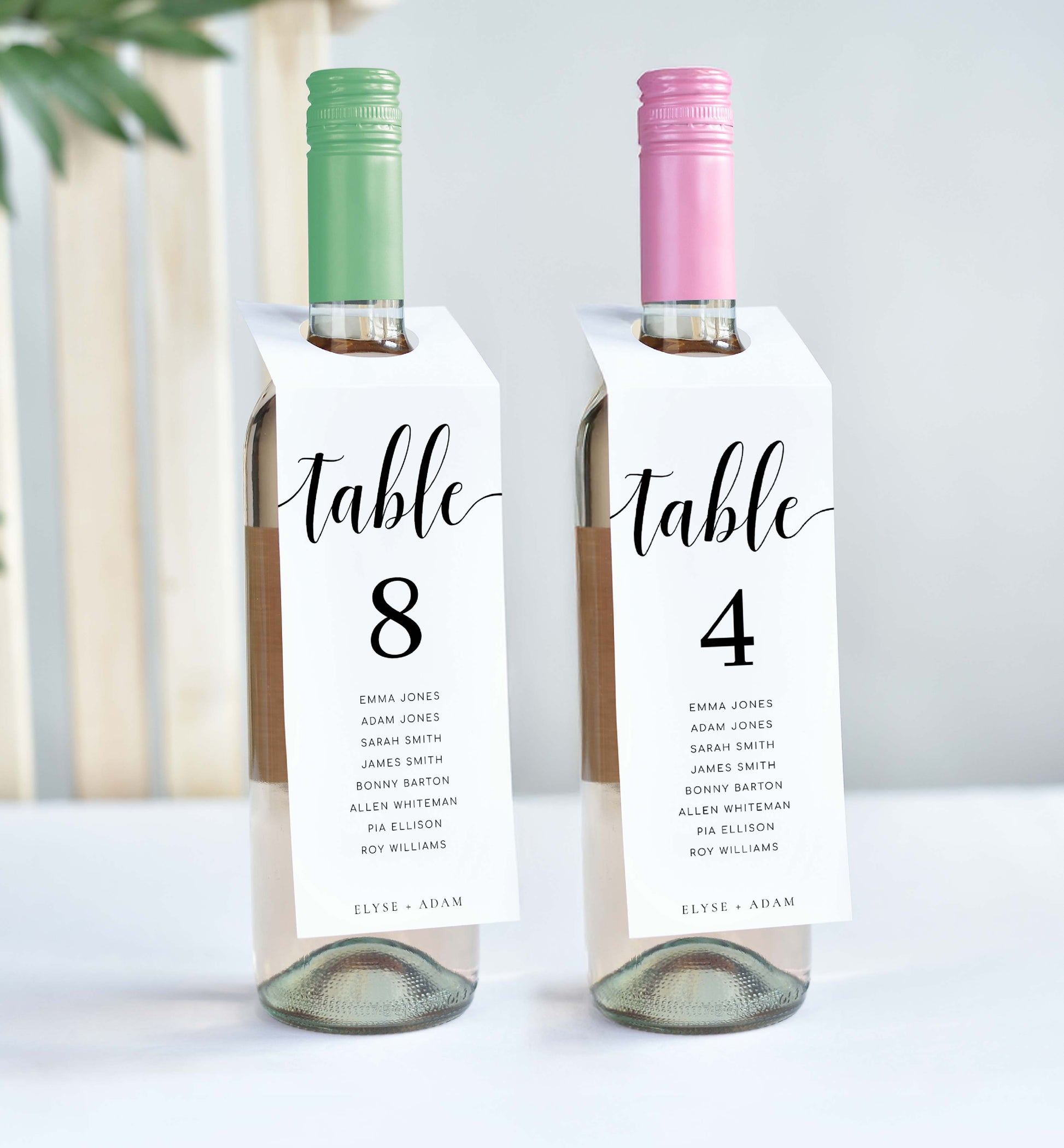 Two wine bottles with table number labels on a white background. Printable Table Number Wine Bottle Tags, Minimalist Wedding Table Numbers, Table Seating Plan Cards, Table Numbers with Guest Names, Leyton