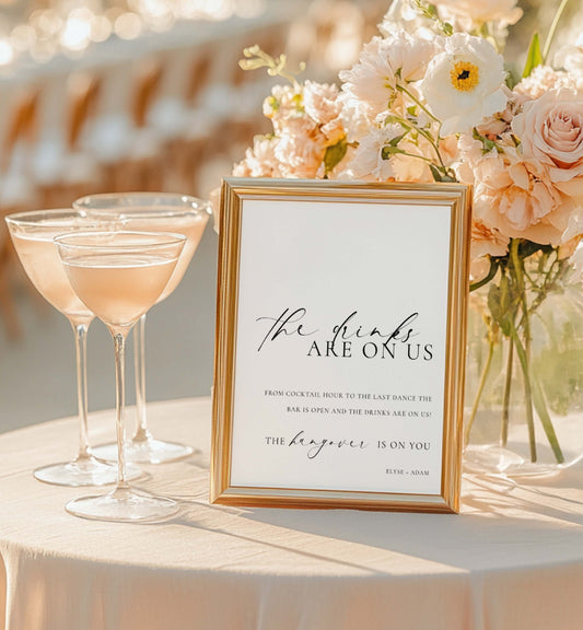 Framed sign with humorous wedding reception message next to cocktails and flowers. Printable Open Bar Sign Template, Minimalist Wedding Open Bar Sign, Printable Drinks Are On Us Sign, Wedding Bar Menu Sign, Ellesmere