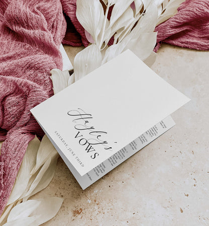 Book titled 'Hayley's Vows' on a surface with pink fabric and white flowers. Printable His And Her Vow Books, Bride and Groom Wedding Day Card Template, Minimalist Wedding Vows Card, Wedding Ceremony Card Ellesmere