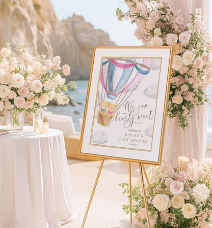 Decorative sign with a hot air balloon design on an easel surrounded by flowers and candles outdoors. Printable We Can Bearly Wait Hot Air Balloon Boy and Girl Twins Teddy Bear Welcome Sign Template