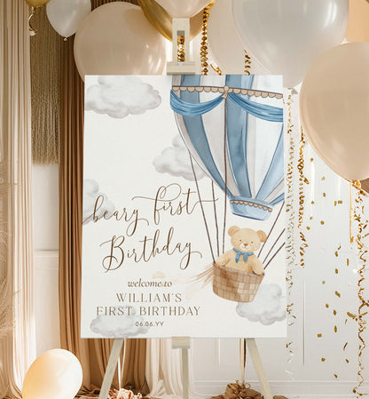 Decorative sign for a first birthday party with a teddy bear in a hot air balloon, surrounded by balloons and decorations. Printable Teddy Bear Welcome Sign Template, Beary First Birthday Welcome Sign, Blue Hot Air Balloon 1st Birthday Welcome Sign