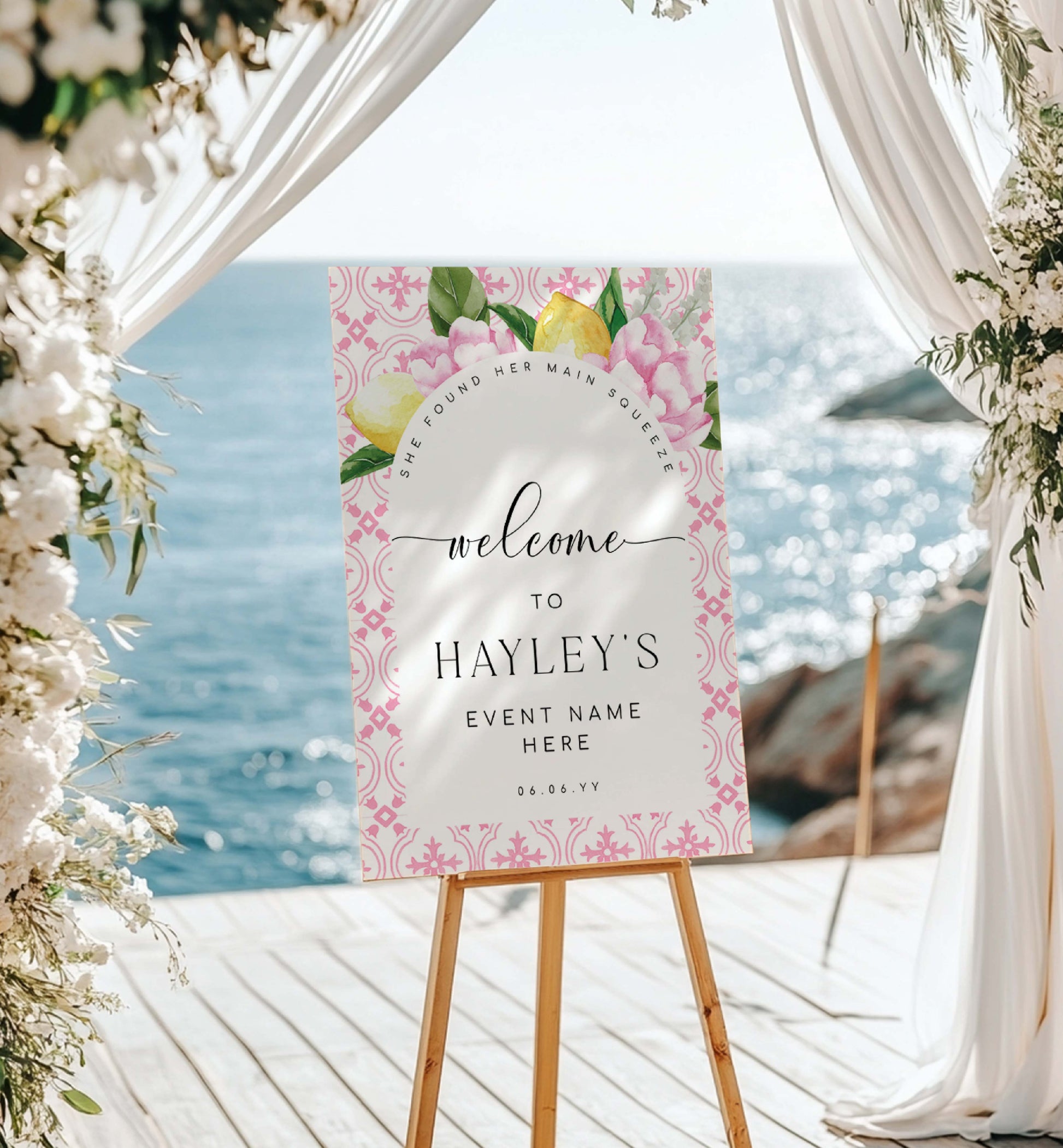 Decorative sign on an easel with floral design and text, set against a scenic background.