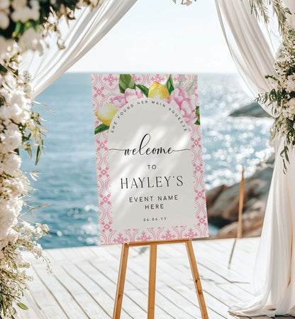 Decorative sign on an easel with floral design and text, set against a scenic background.